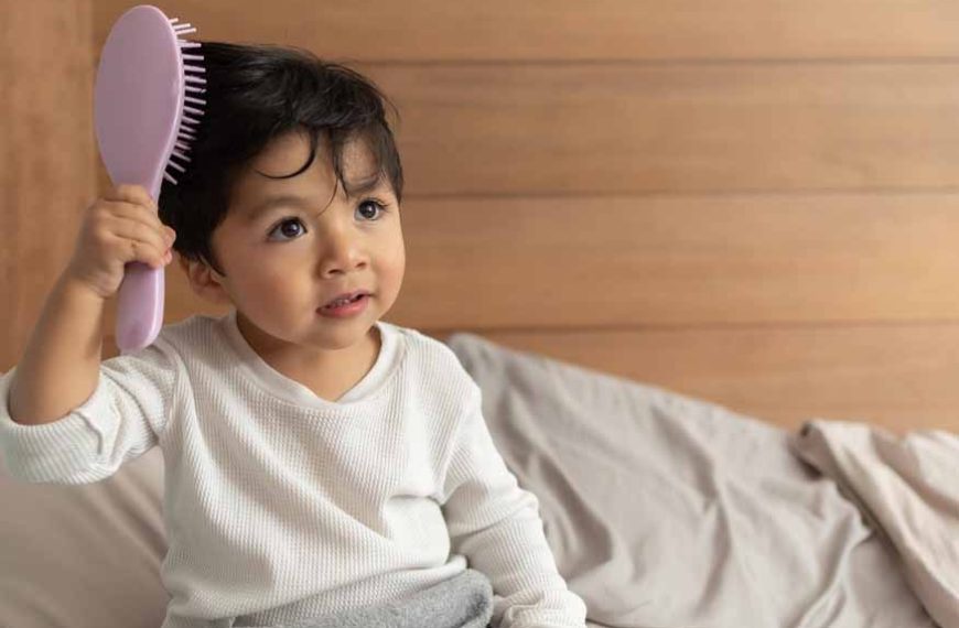 A parent carefully brushing a toddler’s hair in a bright bathroom mirror, checking the scalp with a calm expression, realistic family photograph