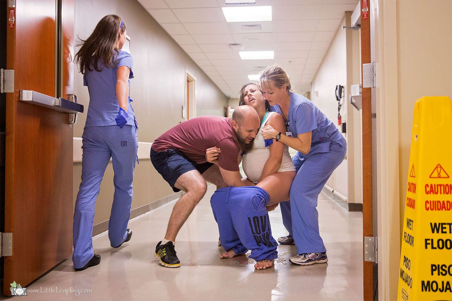 A parent holding a preschooler’s hand while walking down a bright hospital hallway before a scheduled procedure, documentary style photo