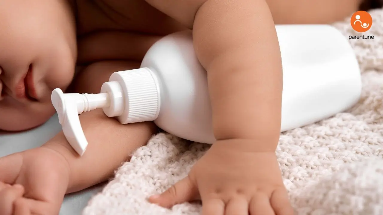 A real photograph of a parent gently applying fragrance-free moisturizer to a newborn’s lower leg on a soft towel after a bath, warm home lighting