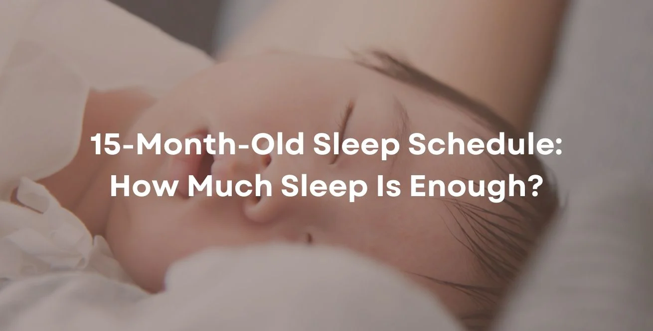 A tired 15-month-old toddler in footed pajamas being carried by a parent down a softly lit hallway toward a crib at bedtime, candid real-life photo