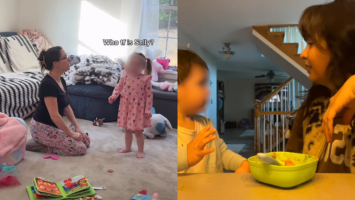 A toddler sitting on a living room rug looking up at a parent who is speaking, with toys nearby, real-life candid photo