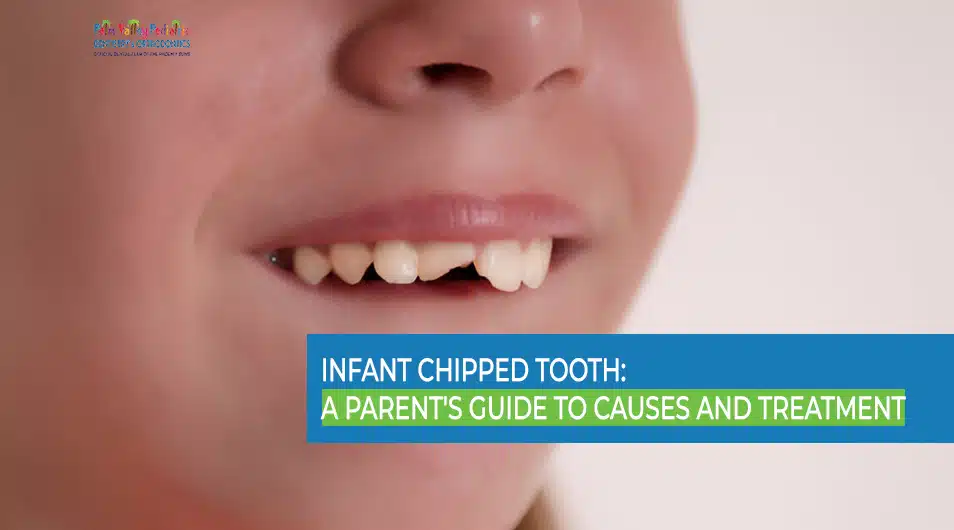 Close-up photo of a toddler smiling slightly with a small visible chip on a front baby tooth in natural indoor light